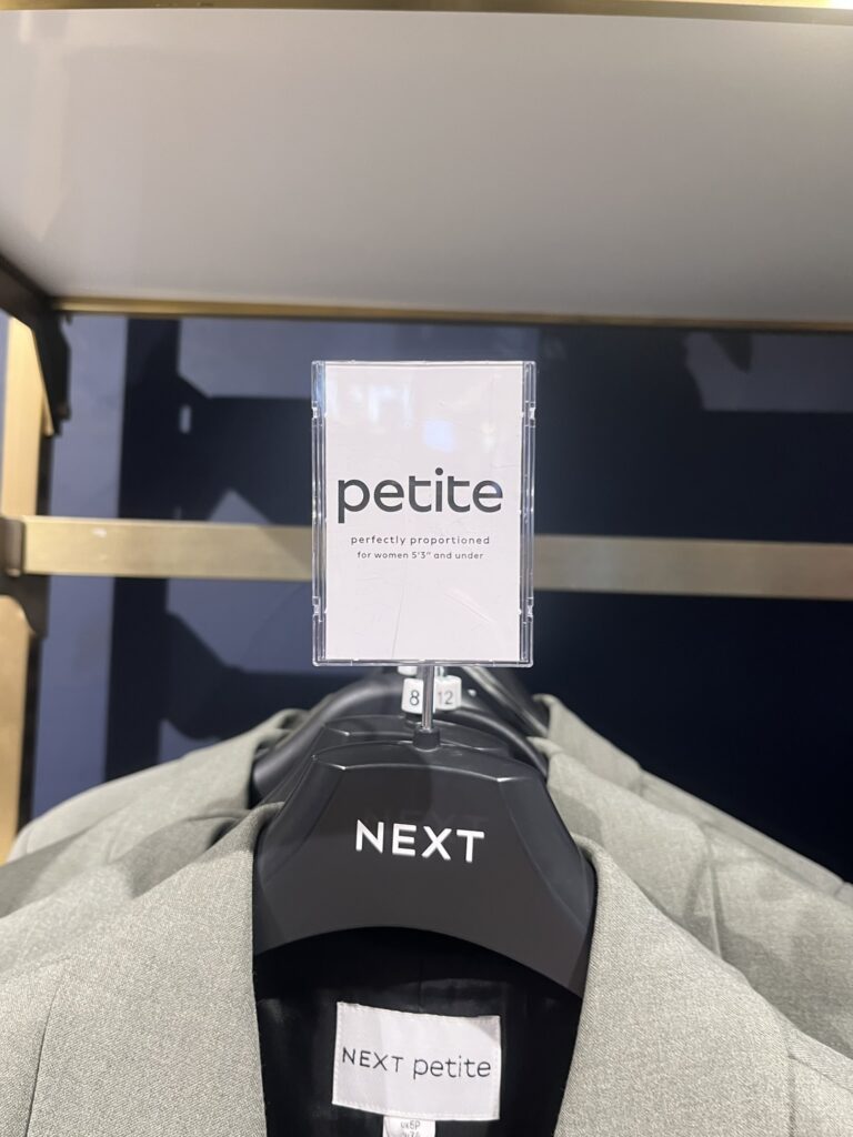 A8 Portrait Reflex Sign Holder Plastic Graphic Display Solution in Next Fashion Retailer Petite Womenswear Department